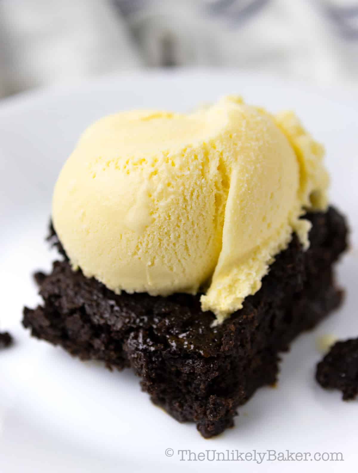 Dulce de leche brownie with a scoop of vanilla ice cream in top.