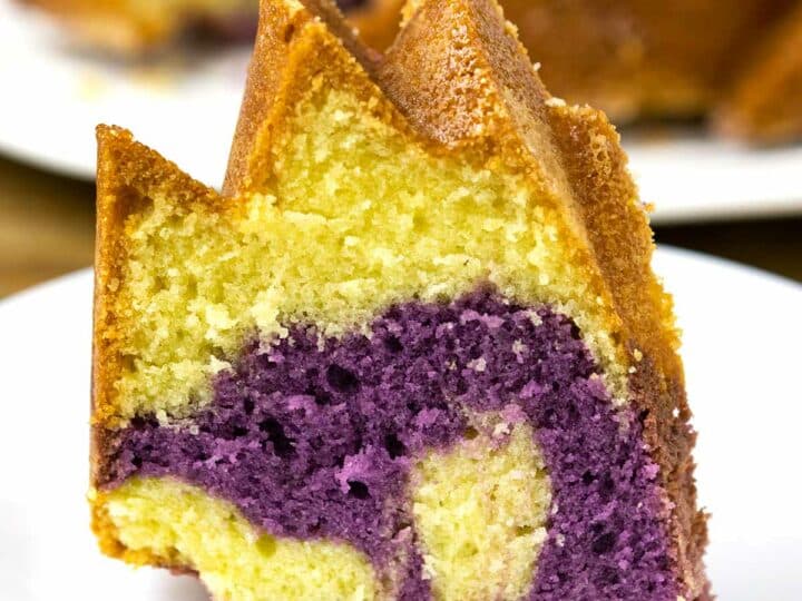 A slice of ube pound cake on a plate.