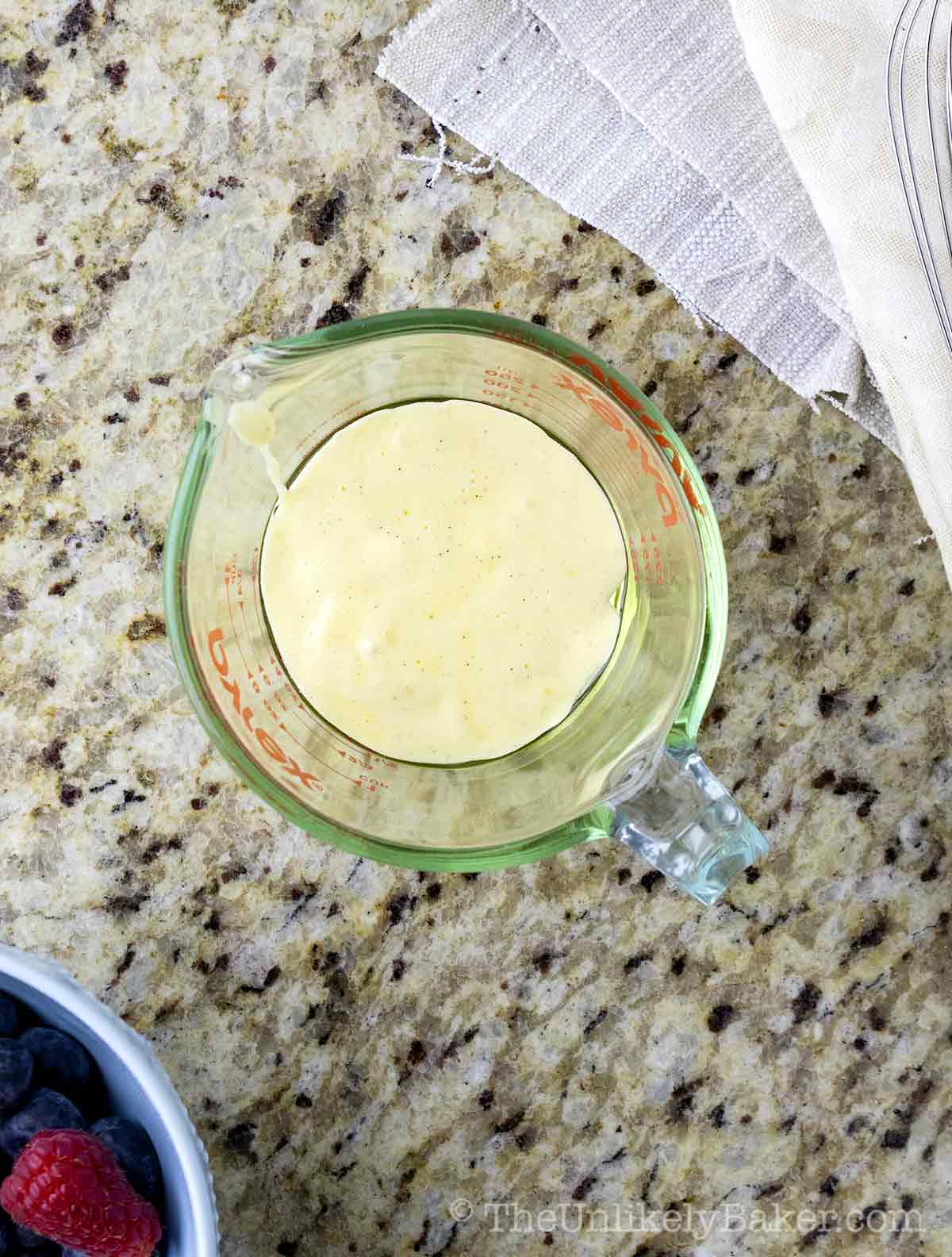 Cake batter with oil in a measuring cup.