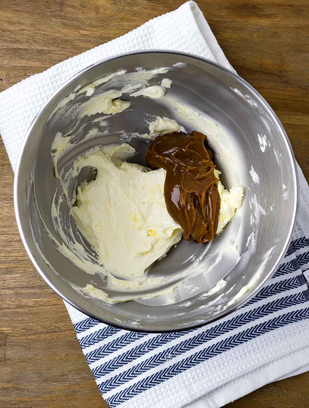 Dulce de leche and creamed butter in a bowl.