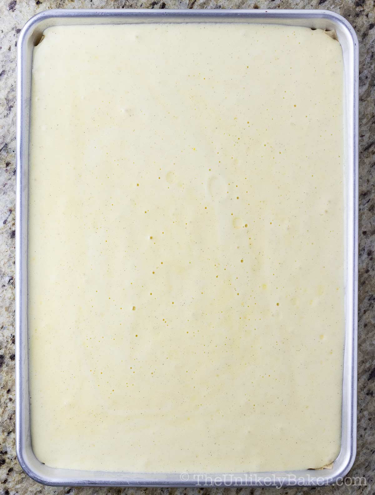 Cake batter in jelly roll pan.