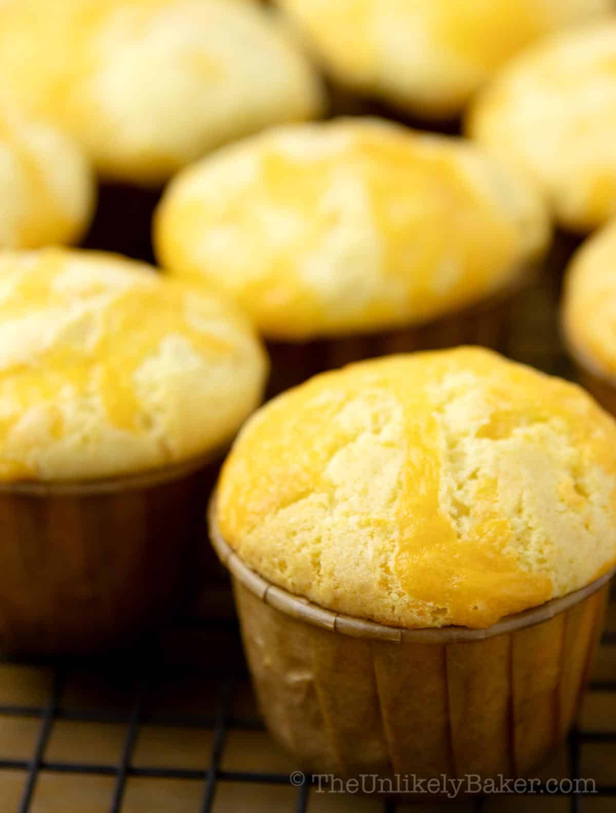 Cheddar cheese cupcakes on a wire rack.