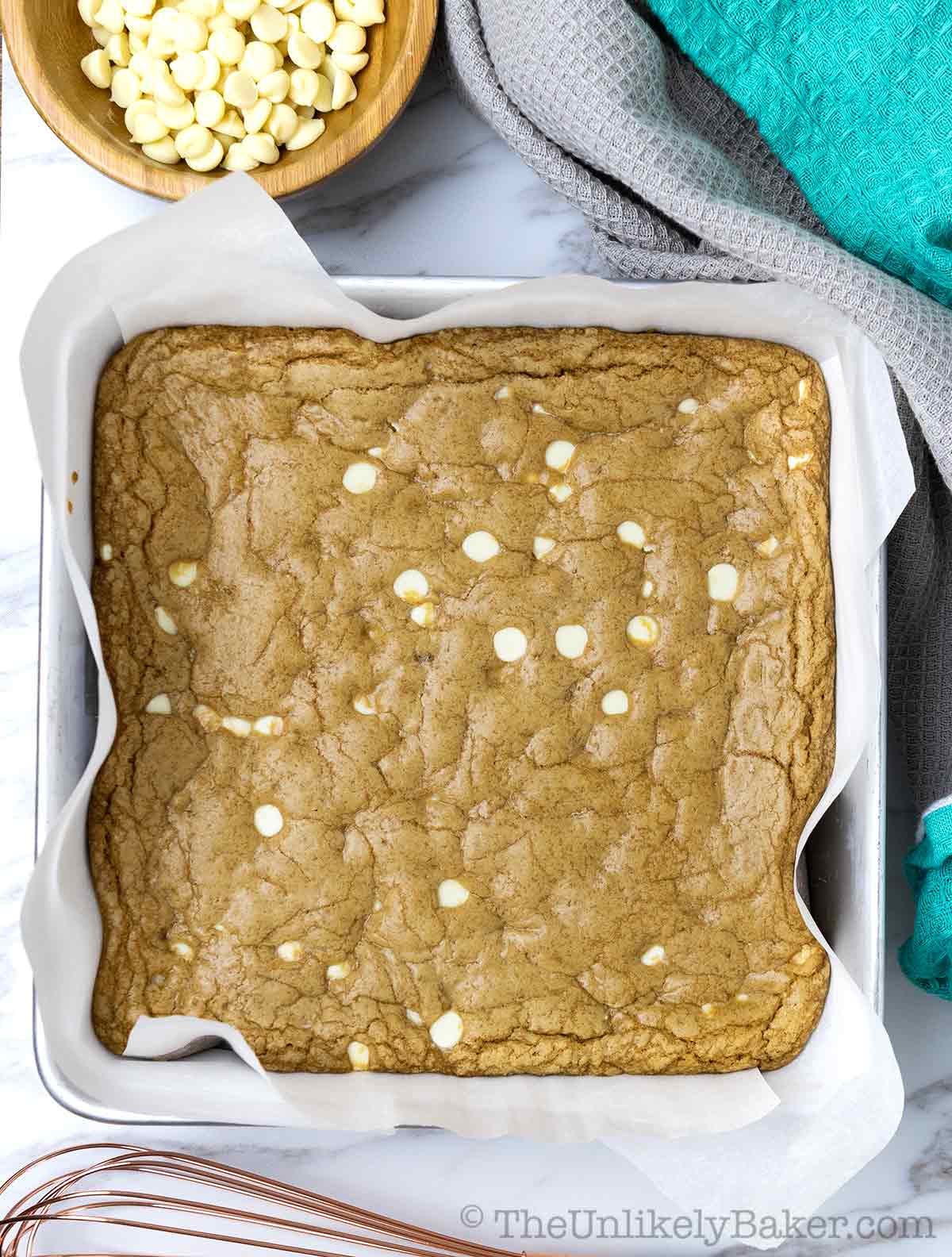 Freshly baked white chocolate cookie butter blondies in a pan.