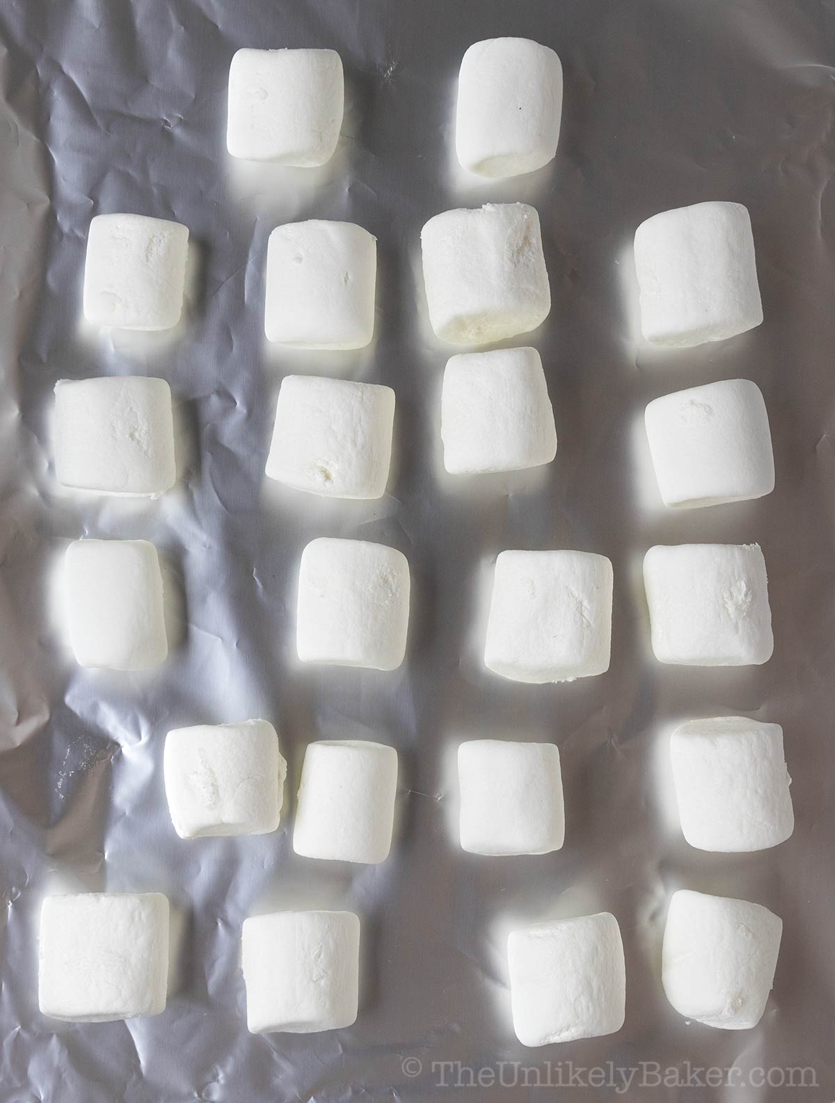 Jumbo marshmallows on foil.