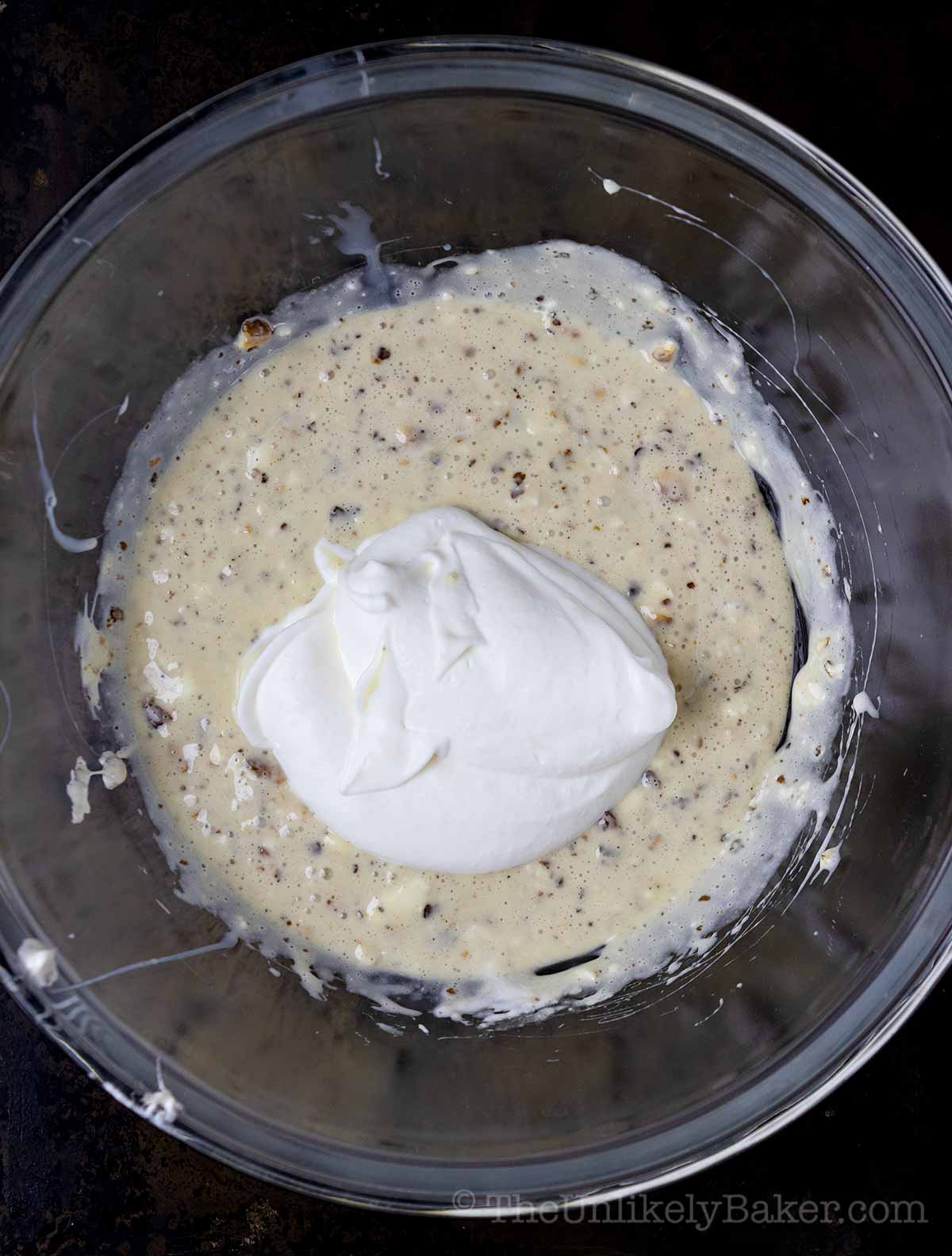 Dollop of whipped cream added to ice cream base.