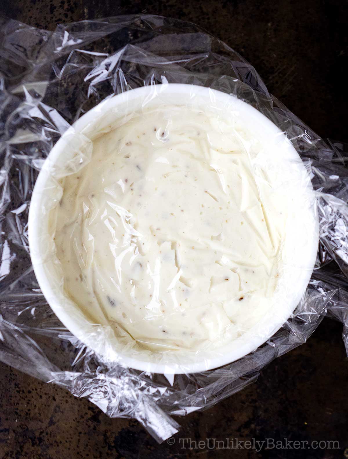 Ice cream with plastic wrap on top.