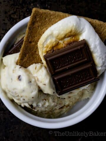 Scoops of marshmallow ice cream topped with s'mores.