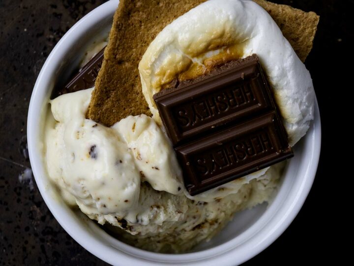 Scoops of marshmallow ice cream topped with s'mores.