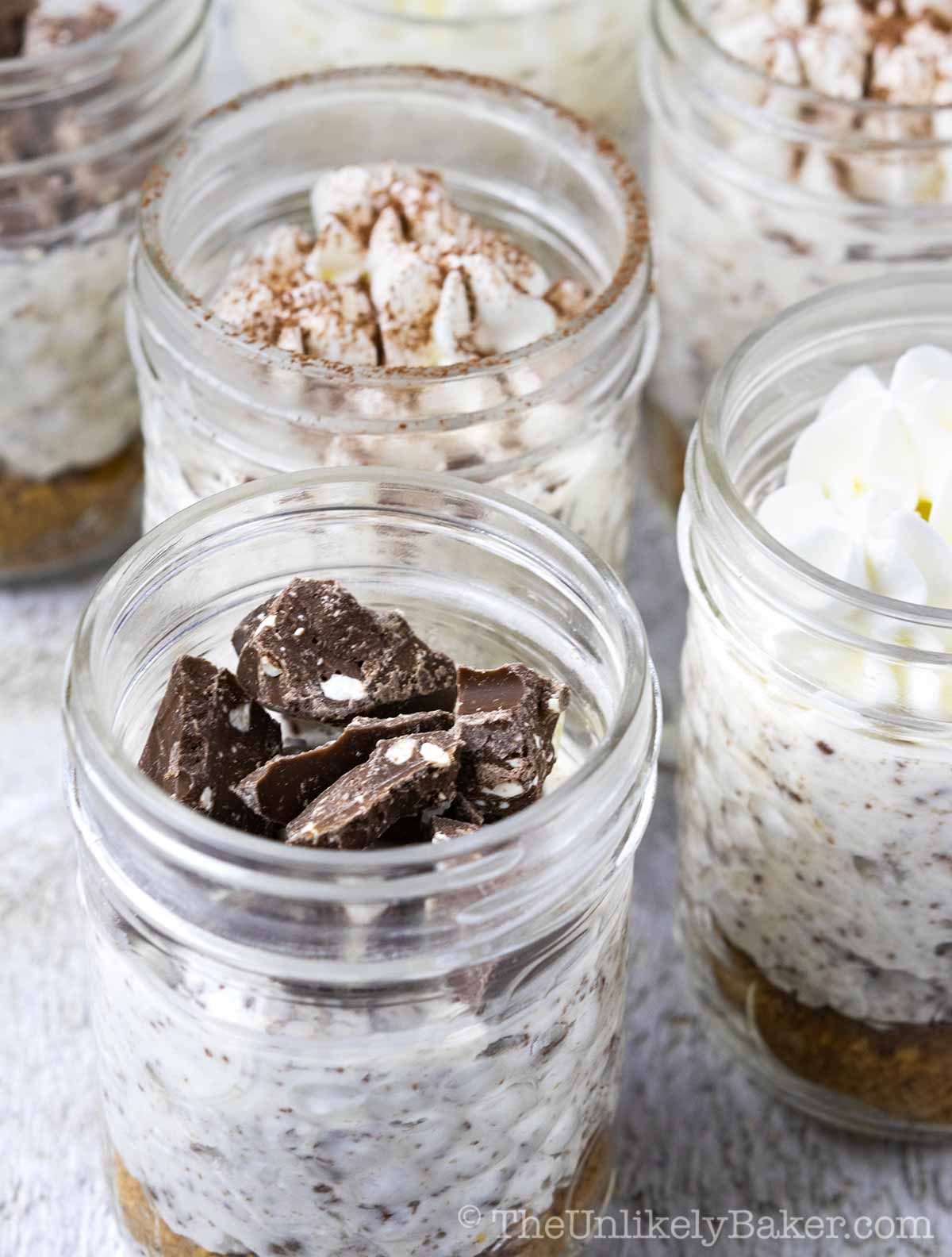 Jars of Toblerone cheesecake with a variety of toppings.