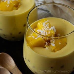 Closeup shot of mango chunks on top of a glass of mango sago.