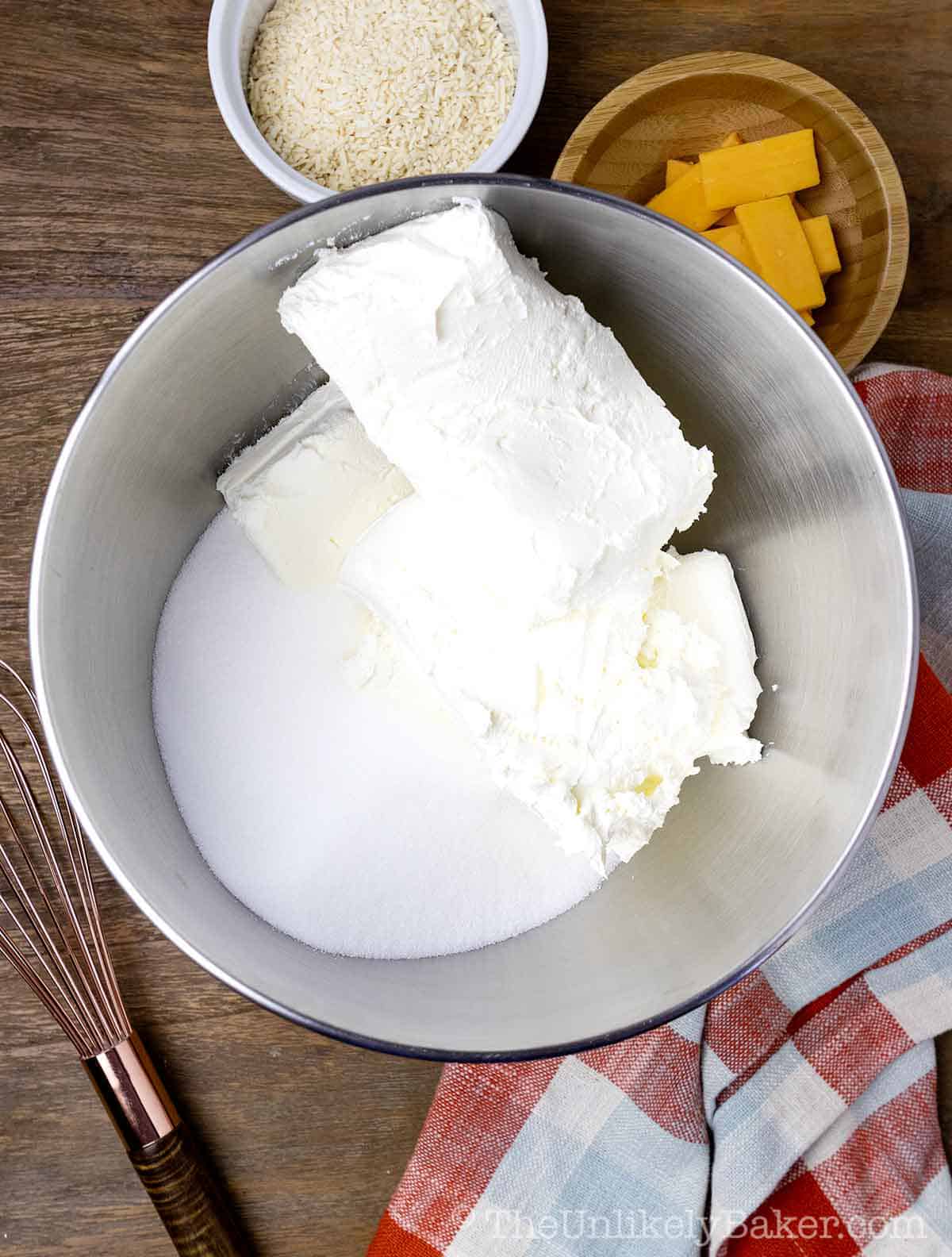 Cream cheese and sugar in a bowl.