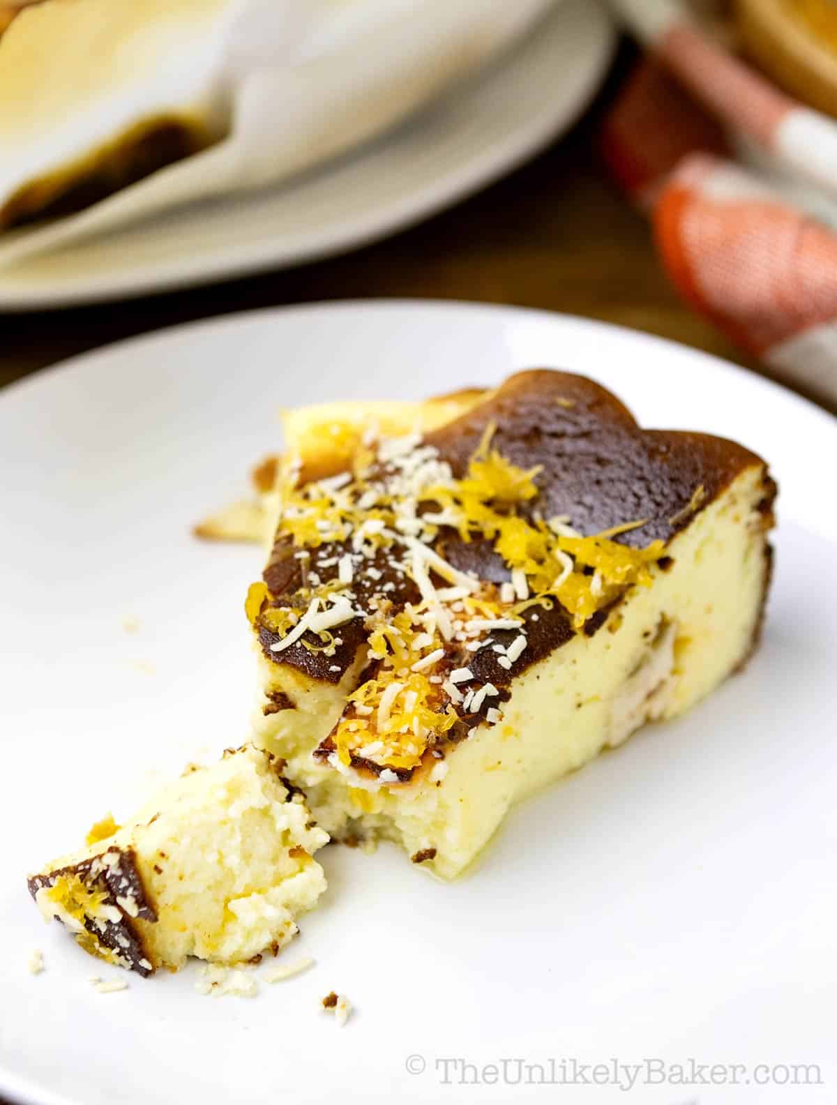 A slice of creamy bibingka burnt cheesecake on a plate.