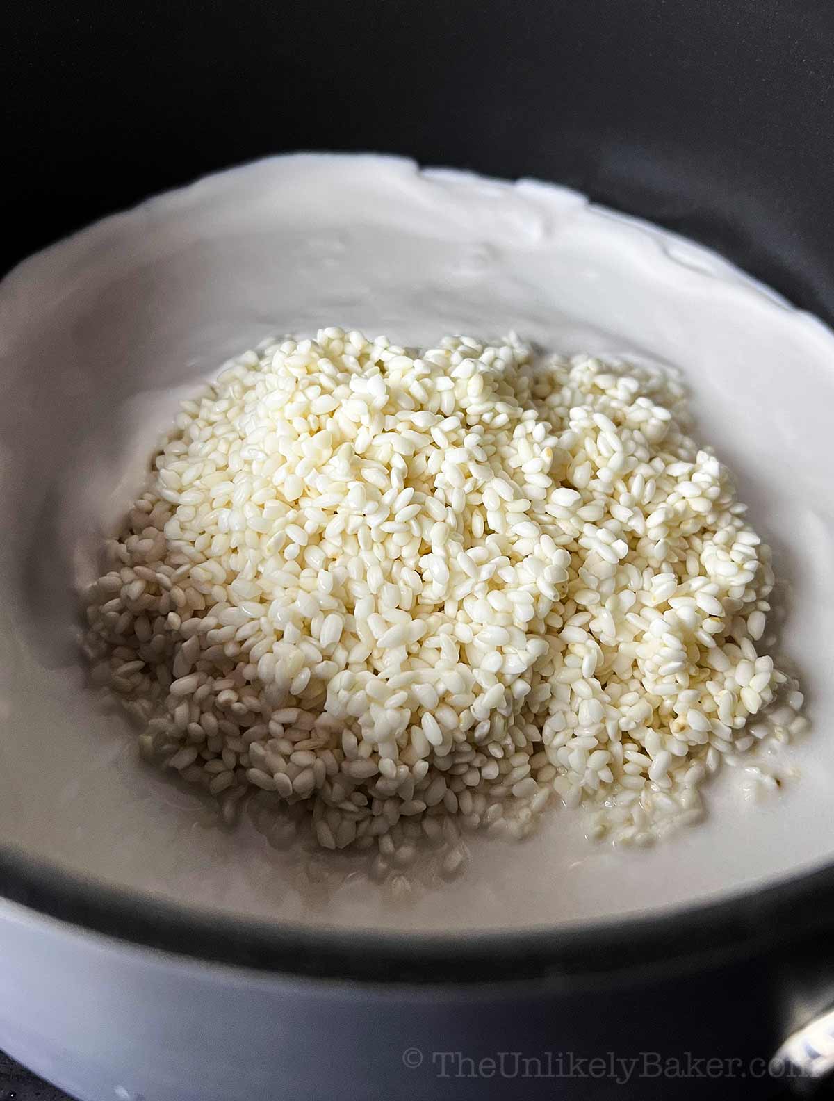 Glutinous rice combined with coconut milk in a saucepan.