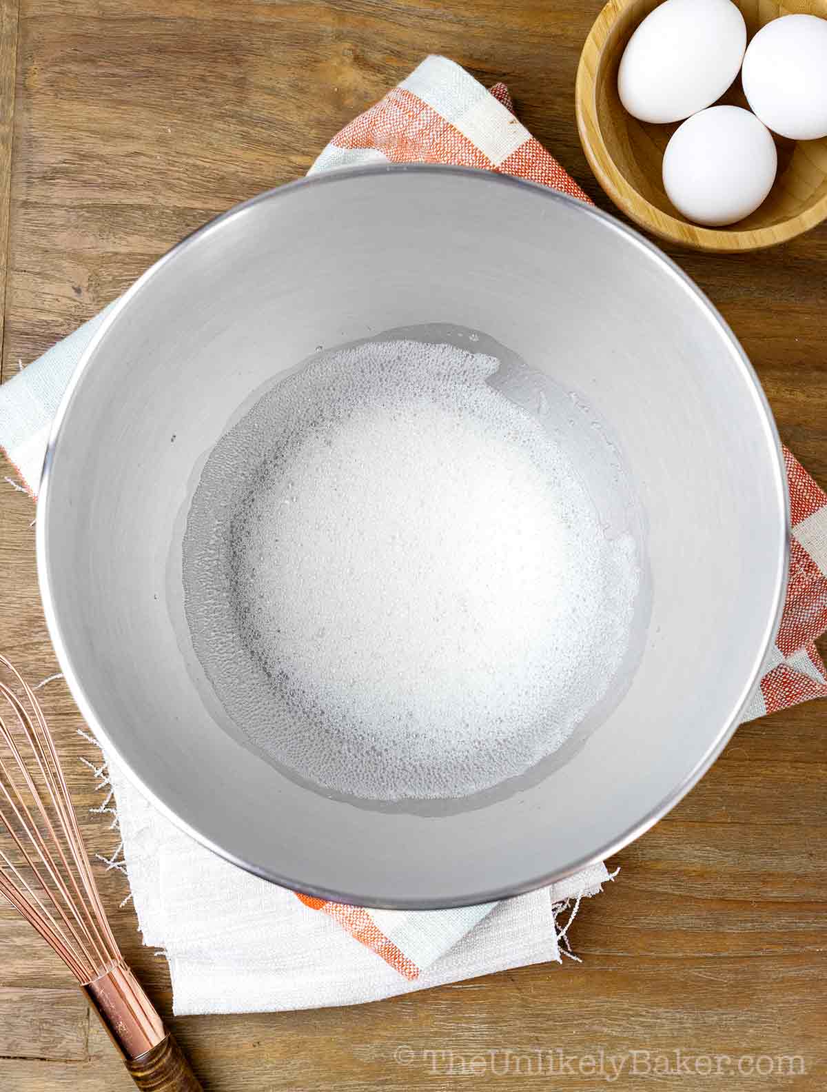 Foamy egg whites in a bowl.
