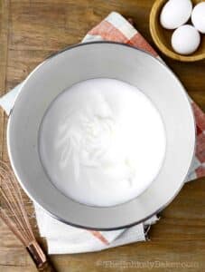 Stiff egg whites in a bowl.