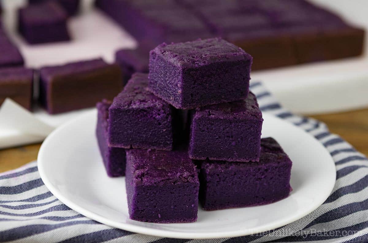 Slices of ube mochi brownies on a plate.