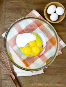 Eggs yolks and sugar in a bowl.