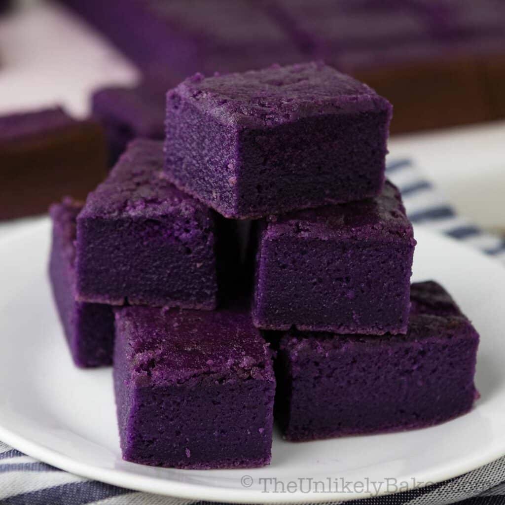 Slices of ube mochi on a plate.