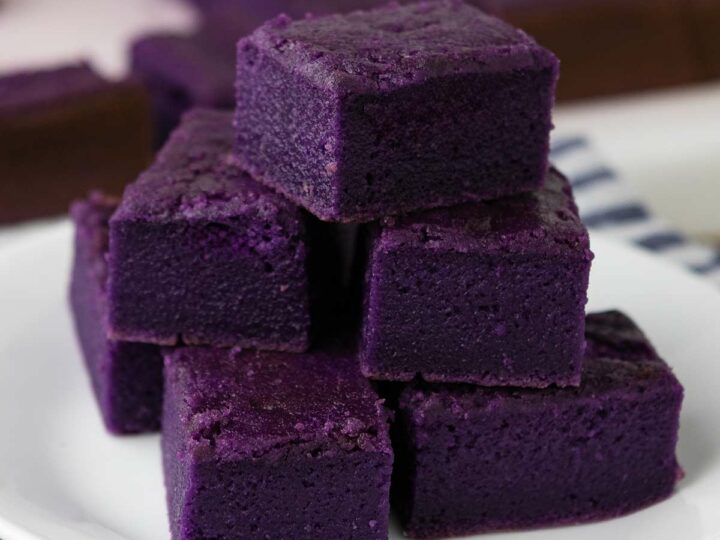 Slices of ube mochi on a plate.