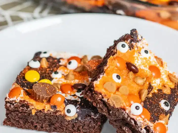 Two slices of Halloween brownies with peanut butter cups.