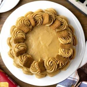 Delicious Biscoff cake topped with Biscoff biscuits on a serving platter.