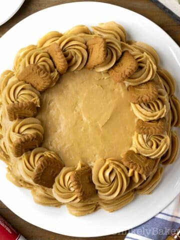 Delicious Biscoff cake topped with Biscoff biscuits on a serving platter.