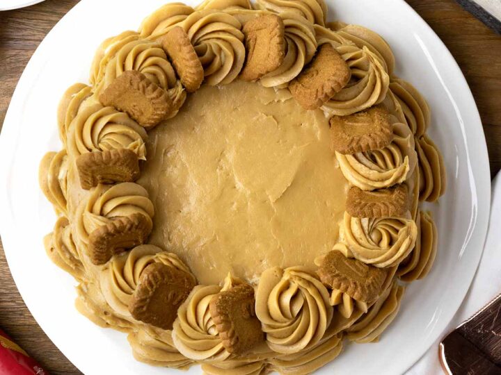 Delicious Biscoff cake topped with Biscoff biscuits on a serving platter.