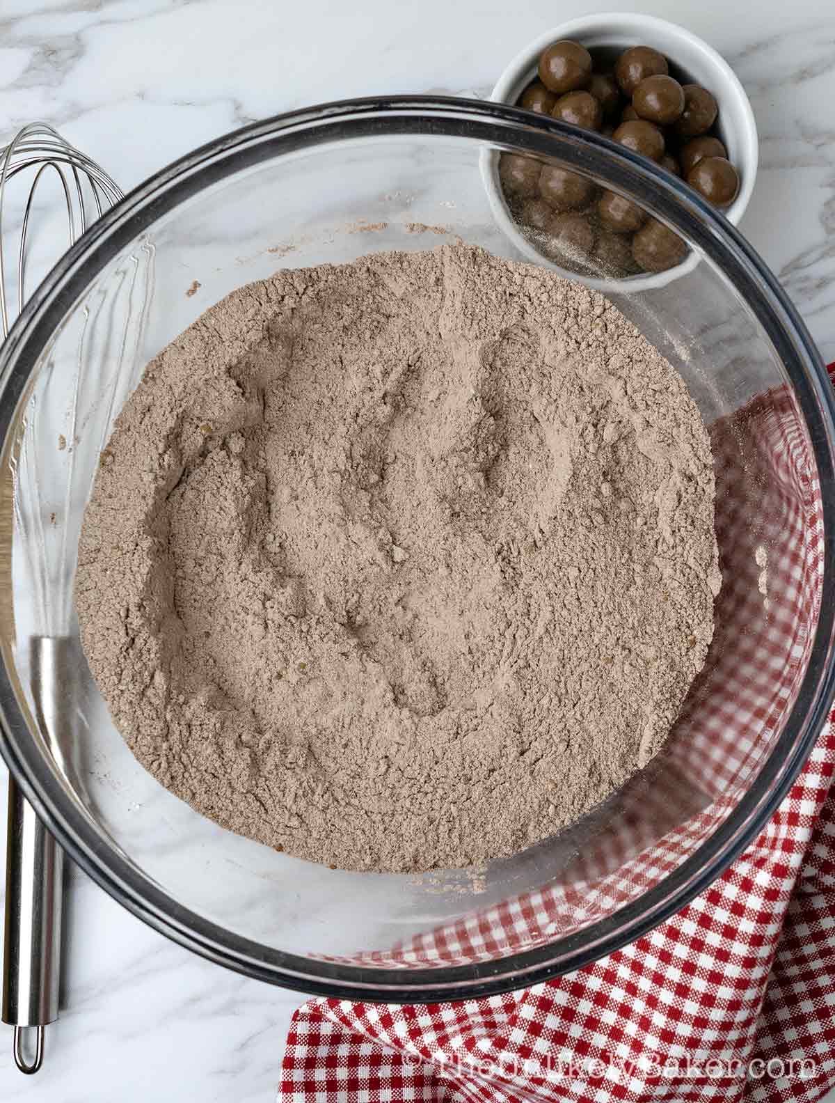Flour mixture with malted chocolate powder in a bowl.