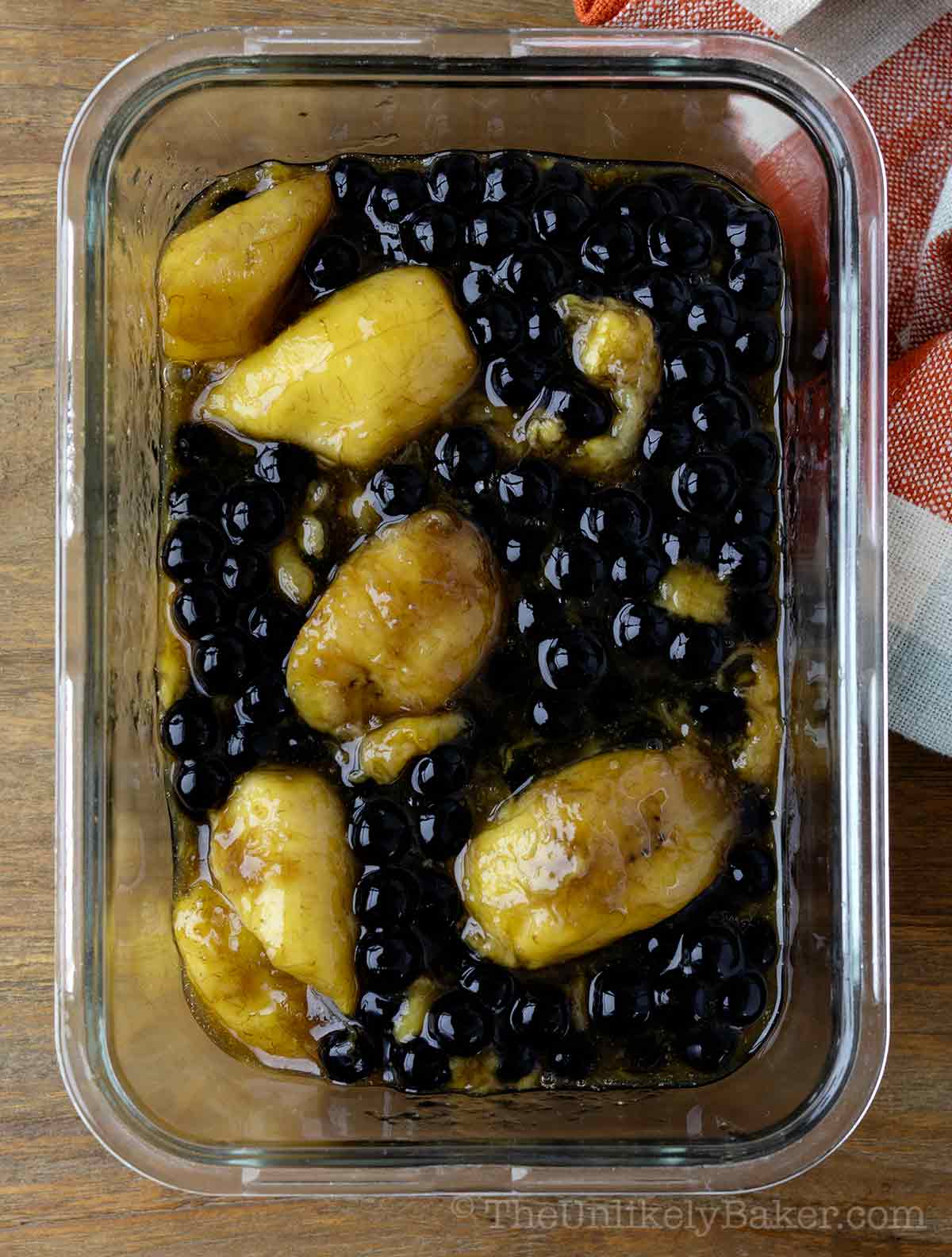 A container filled with minatamis na saging with sago.