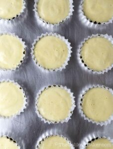 Batter in molds on a pan.