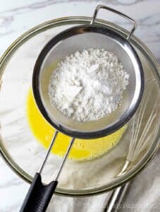 Dry ingredients sifted into egg yolk mixture.