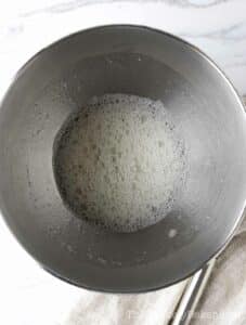 Foamy egg whites in a bowl.