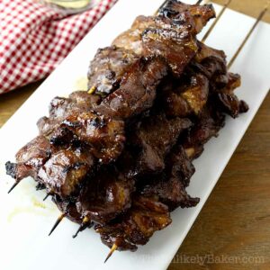 Filipino pork BBQ skewers on a plate.