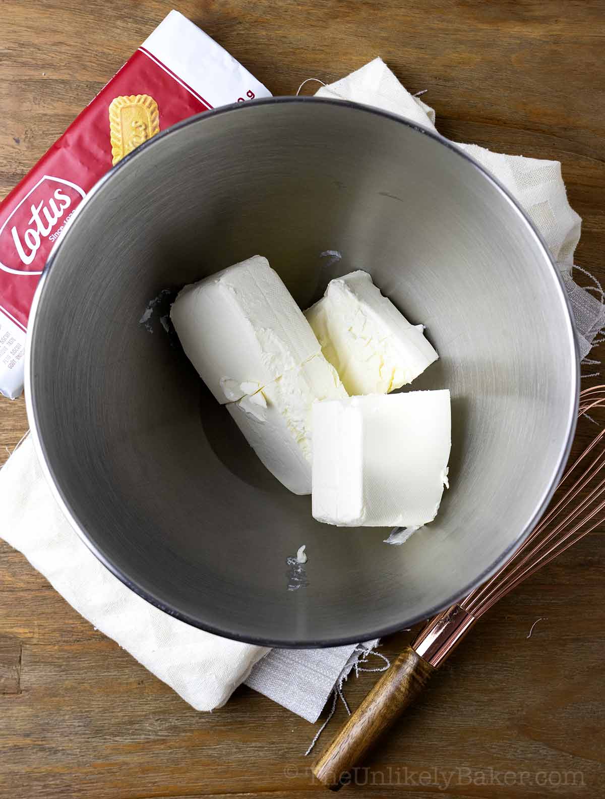 Blocks of cream cheese in a bowl.