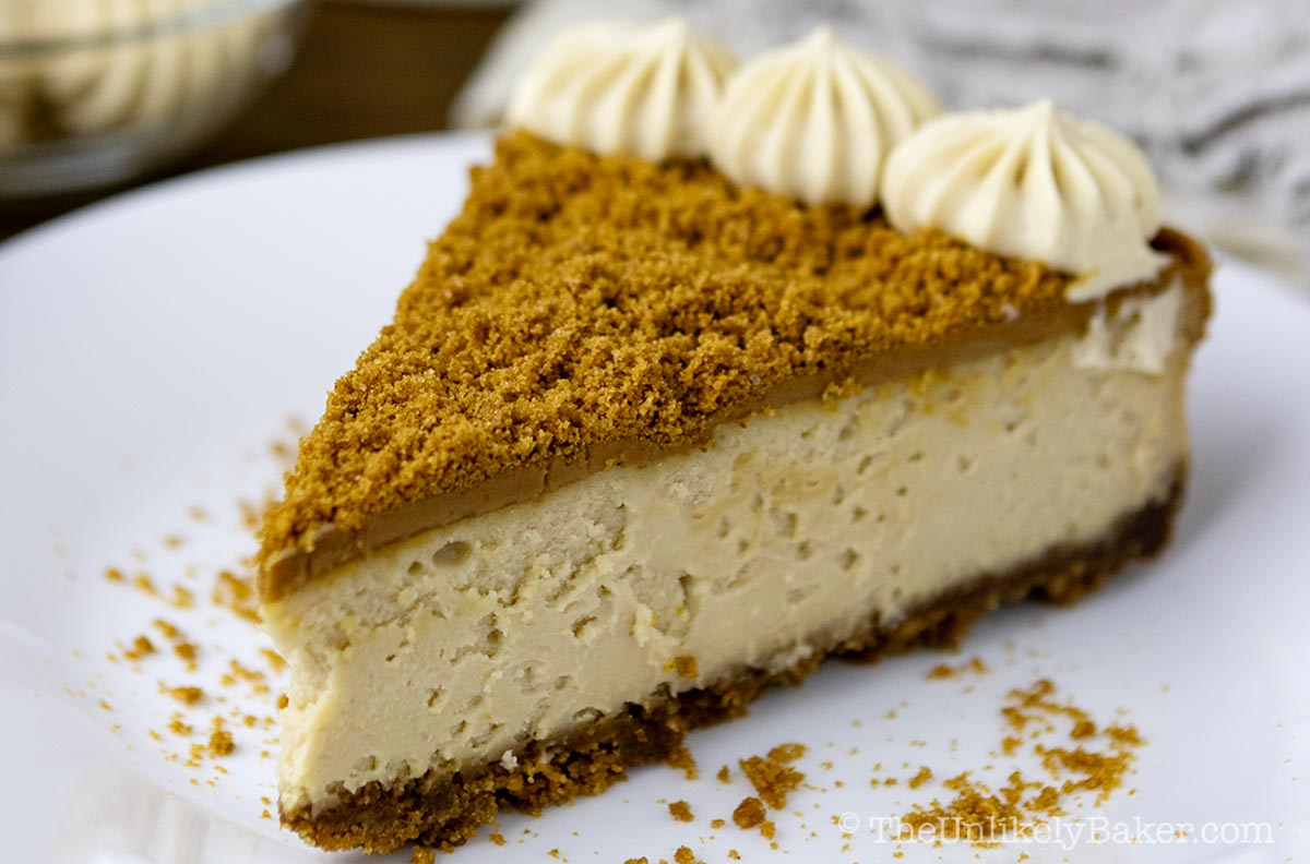 A slice of Biscoff cheesecake on a plate.