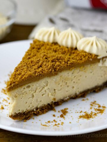 A slice of Biscoff cheesecake on a plate.