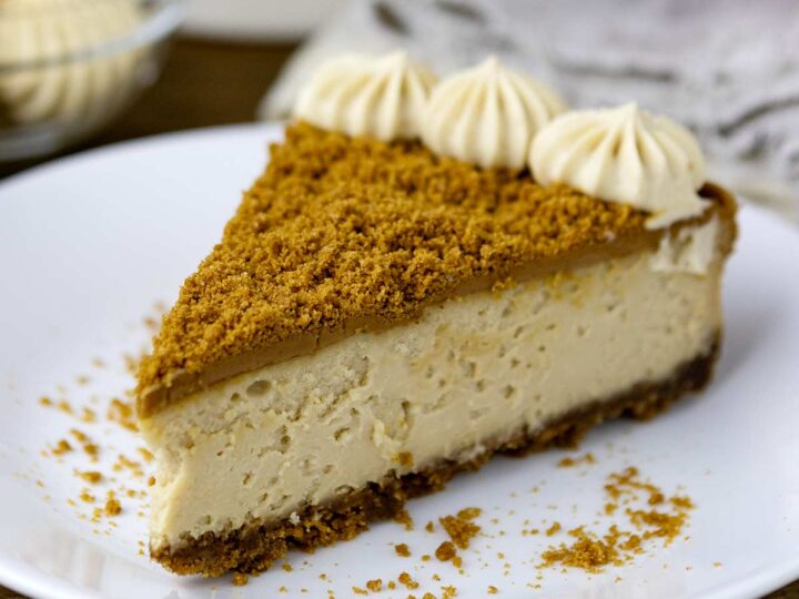 A slice of Biscoff cheesecake on a plate.