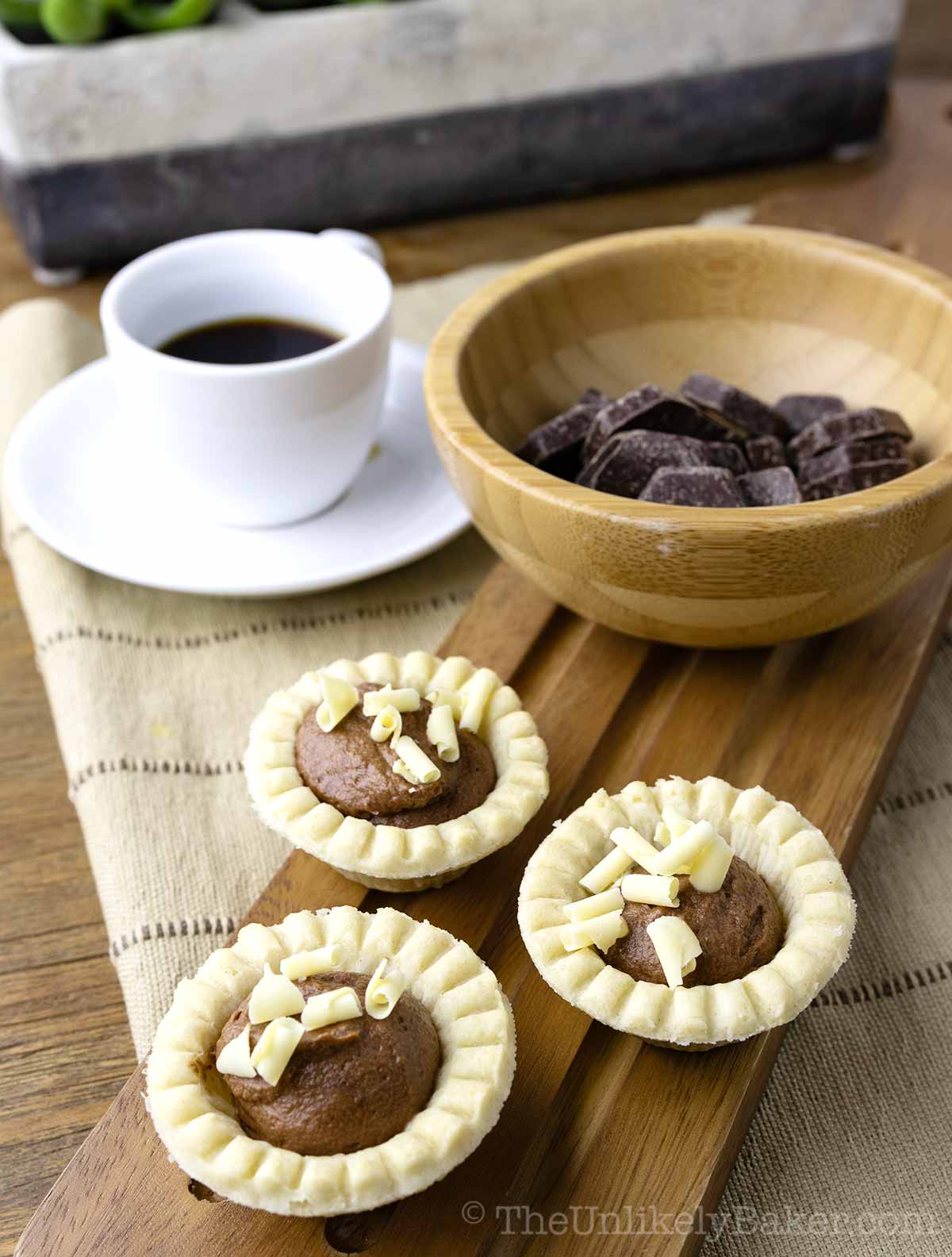 Chocolate tarts mini on a serving platter.