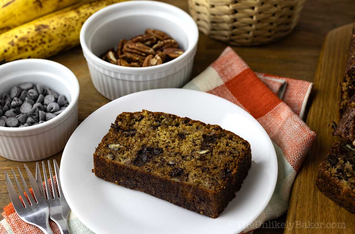 Banana bread with pecans and chocolate chips on a plate.