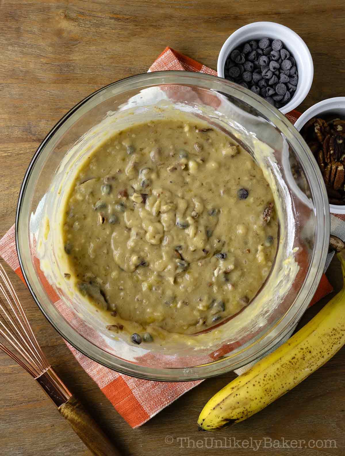 Batter for banana bread with pecans and chocolate chips.