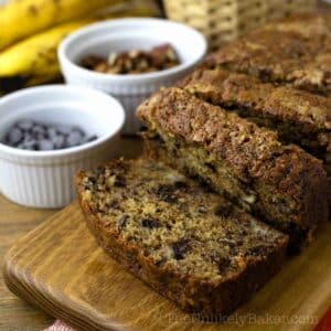 Banana bread with pecans on a serving platter.