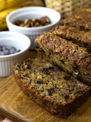 Banana bread with pecans on a serving platter.