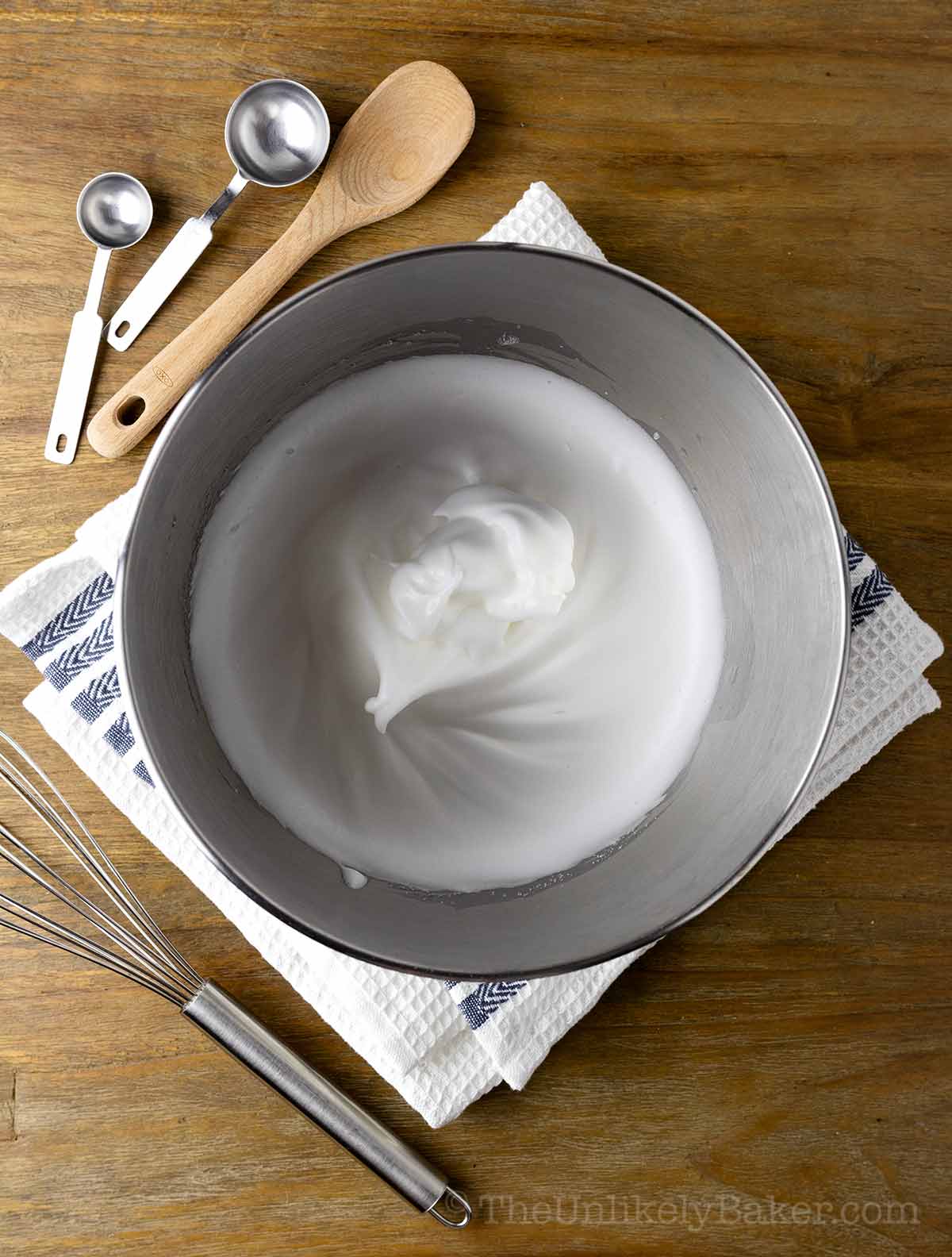 Egg whites with stiff peaks in a bowl.