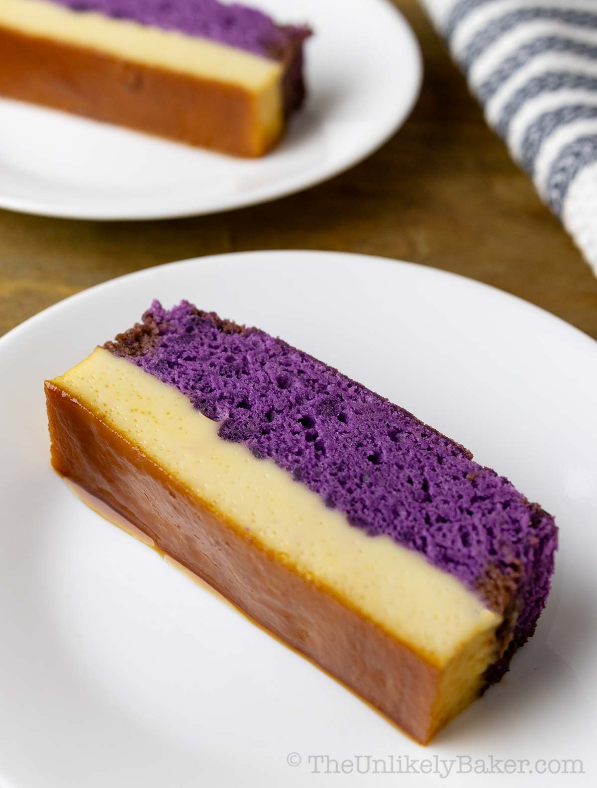 A slice of ube flan cake on a plate.