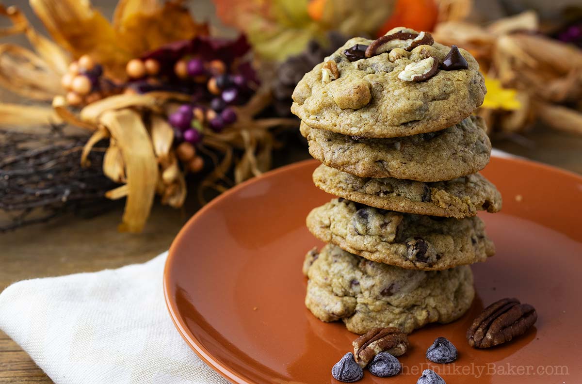 A stack of pecan cookies on a plate.