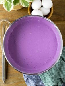 Ube basque cheesecake batter in a bowl.