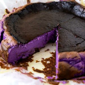 Basque cheesecake showing the vibrant purple ube filling.