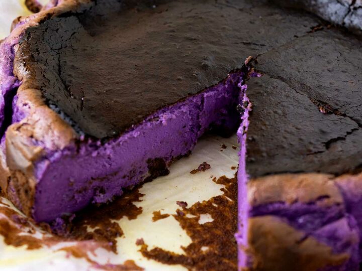 Basque cheesecake showing the vibrant purple ube filling.