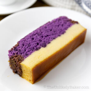 A slice of ube cake flan on a plate.