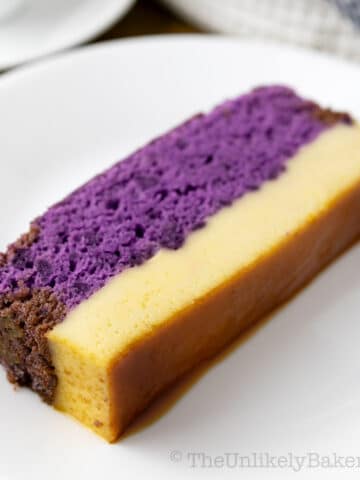 A slice of ube cake flan on a plate.